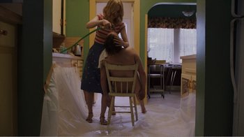 Movie still from “Don't Worry, He Won't Get Far on Foot” (2018), directed by Gus Van Sant – A woman standing over a man sitting in a chair; Medium shot, Low angle