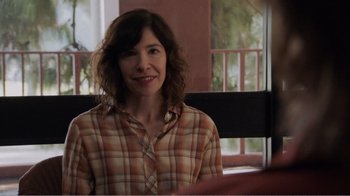 Movie still from “Don't Worry, He Won't Get Far on Foot” (2018), directed by Gus Van Sant – A woman in a plaid shirt sitting at a table; Close Up shot, Over the shoulder angle