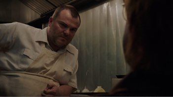 Movie still from “Don't Worry, He Won't Get Far on Foot” (2018), directed by Gus Van Sant – A man sitting in front of a woman in front of a mirror; Close Up shot, Over the shoulder angle