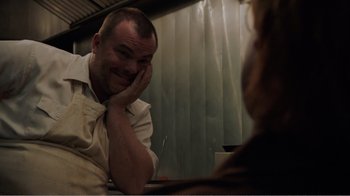 Movie still from “Don't Worry, He Won't Get Far on Foot” (2018), directed by Gus Van Sant – A man sitting in front of a woman in front of a mirror; Close Up shot, Over the shoulder angle