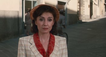 Movie still from “Life Is Beautiful” (1997), directed by Roberto Benigni – A woman wearing a hat and a jacket; Close Up shot, Over the shoulder angle