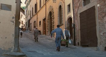 Movie still from “Life Is Beautiful” (1997), directed by Roberto Benigni – A group of people walking down a street; Extreme Wide shot, High angle