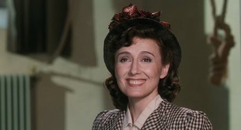 Movie still from “Life Is Beautiful” (1997), directed by Roberto Benigni – A woman wearing a hat and a checkered jacket; Close Up shot, Low angle