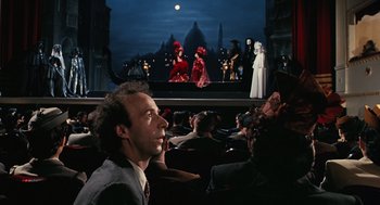 Movie still from “Life Is Beautiful” (1997), directed by Roberto Benigni – A crowd of people sitting in front of a screen; Wide shot, Over the shoulder angle