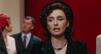Movie still from “Life Is Beautiful” (1997), directed by Roberto Benigni – A woman in a black dress and a man in a red suit; Close Up shot, Over the shoulder angle