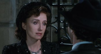 Movie still from “Life Is Beautiful” (1997), directed by Roberto Benigni – A person wearing a suit and hat; Close Up shot, Over the shoulder angle
