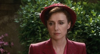 Movie still from “Life Is Beautiful” (1997), directed by Roberto Benigni – A person wearing a suit and a hat; Close Up shot, Over the shoulder angle
