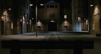 Movie still from “Life Is Beautiful” (1997), directed by Roberto Benigni – An empty street at night with lights on the ground; Extreme Wide shot, High angle