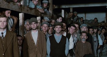Movie still from “Life Is Beautiful” (1997), directed by Roberto Benigni – A group of men standing next to each other in a room; Medium shot, High angle
