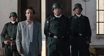 Movie still from “Life Is Beautiful” (1997), directed by Roberto Benigni – A group of men standing next to each other in uniforms; Medium shot, Low angle