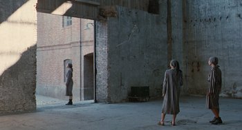 Movie still from “Life Is Beautiful” (1997), directed by Roberto Benigni – Two people are standing in an open doorway; Extreme Wide shot, Over the shoulder angle