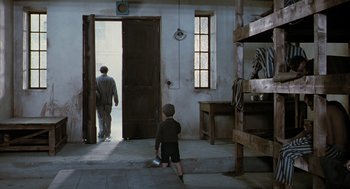 Movie still from “Life Is Beautiful” (1997), directed by Roberto Benigni – A man and a boy are in a jail cell; Wide shot, High angle