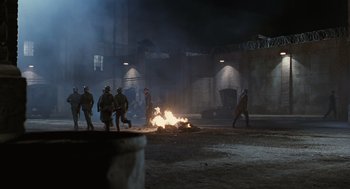 Movie still from “Life Is Beautiful” (1997), directed by Roberto Benigni – A group of people walking around a fire; Extreme Wide shot, High angle