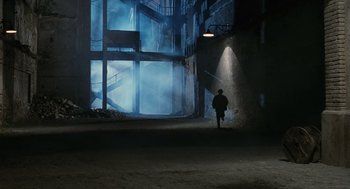 Movie still from “Life Is Beautiful” (1997), directed by Roberto Benigni – A man is walking in a dimly - lit room; Extreme Wide shot, High angle