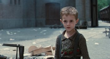 Movie still from “Life Is Beautiful” (1997), directed by Roberto Benigni – A young boy standing in an abandoned building; Medium shot, Over the shoulder angle