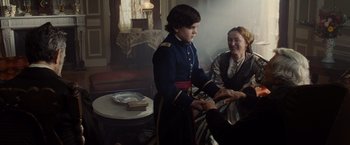 Movie still from “Lincoln” (2012), directed by Steven Spielberg – A man in a military uniform shaking hands with a woman in an old - fashioned dress; Medium shot, Over the shoulder angle