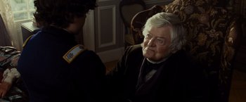 Movie still from “Lincoln” (2012), directed by Steven Spielberg – An old man sitting in a chair looking at a young man; Close Up shot, Over the shoulder angle