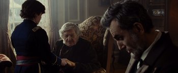 Movie still from “Lincoln” (2012), directed by Steven Spielberg – An older woman sitting in a chair with a younger woman; Medium shot, Over the shoulder angle