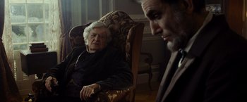 Movie still from “Lincoln” (2012), directed by Steven Spielberg – An old man sitting in a chair next to an older man; Medium shot, Over the shoulder angle