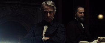 Movie still from “Lincoln” (2012), directed by Steven Spielberg – An older man in a black suit and bow tie; Close Up shot, Over the shoulder angle