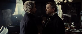 Movie still from “Lincoln” (2012), directed by Steven Spielberg – Two men standing next to each other in front of a window; Close Up shot, Over the shoulder angle