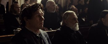 Movie still from “Lincoln” (2012), directed by Steven Spielberg – Two men are sitting in a row in front of a crowd; Close Up shot, Over the shoulder angle