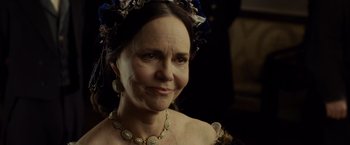 Movie still from “Lincoln” (2012), directed by Steven Spielberg – An older woman wearing a necklace and a flower crown; Close Up shot, Over the shoulder angle