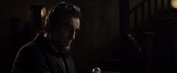 Movie still from “Lincoln” (2012), directed by Steven Spielberg – A person wearing a suit and tie; Close Up shot, Over the shoulder angle