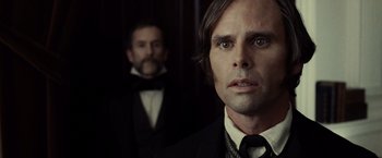 Movie still from “Lincoln” (2012), directed by Steven Spielberg – A man in a suit and tie next to another man in a suit; Close Up shot, Over the shoulder angle