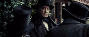 Movie still from “Lincoln” (2012), directed by Steven Spielberg – A man in a black hat and a long coat; Close Up shot, Over the shoulder angle