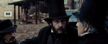 Movie still from “Lincoln” (2012), directed by Steven Spielberg – A man in a top hat and a long beard; Close Up shot, Over the shoulder angle