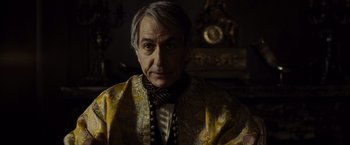 Movie still from “Lincoln” (2012), directed by Steven Spielberg – An older man wearing a yellow and black jacket; Medium shot, Over the shoulder angle