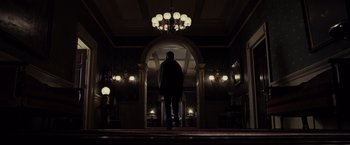 Movie still from “Lincoln” (2012), directed by Steven Spielberg – A man walking down the hall way of a house; Wide shot, Low angle