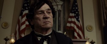 Movie still from “Lincoln” (2012), directed by Steven Spielberg – An older man wearing a suit and a tie; Close Up shot, Low angle
