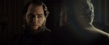 Movie still from “Lincoln” (2012), directed by Steven Spielberg – A man with a long beard is looking at another man with long hair; Close Up shot, Over the shoulder angle