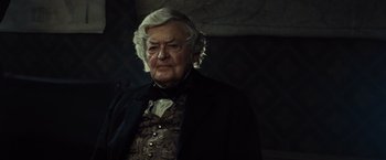 Movie still from “Lincoln” (2012), directed by Steven Spielberg – An old man with white hair wearing a suit and bow tie; Close Up shot, Over the shoulder angle