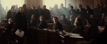 Movie still from “Lincoln” (2012), directed by Steven Spielberg – A group of men sitting in a courtroom; Wide shot, High angle