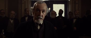 Movie still from “Lincoln” (2012), directed by Steven Spielberg – An old man with a beard and a mustache; Close Up shot, Over the shoulder angle