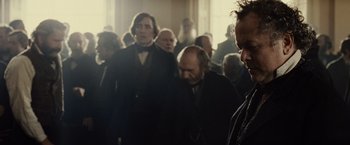 Movie still from “Lincoln” (2012), directed by Steven Spielberg – A group of people in a room with a light shining on them; Close Up shot, Over the shoulder angle