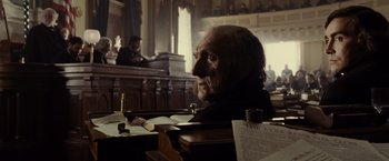 Movie still from “Lincoln” (2012), directed by Steven Spielberg – An old man sitting in a court room with papers; Close Up shot, Over the shoulder angle
