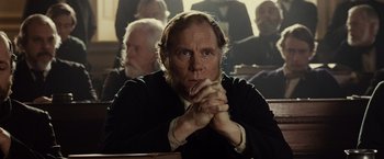 Movie still from “Lincoln” (2012), directed by Steven Spielberg – An old man sitting in front of a group of people; Close Up shot, Over the shoulder angle