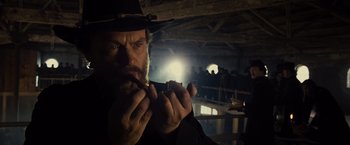 Movie still from “Lincoln” (2012), directed by Steven Spielberg – A man with a beard and a hat smoking a cigarette; Close Up shot, Low angle