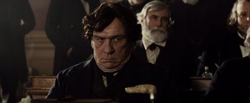 Movie still from “Lincoln” (2012), directed by Steven Spielberg – A man in a black suit and a white beard; Close Up shot, Over the shoulder angle