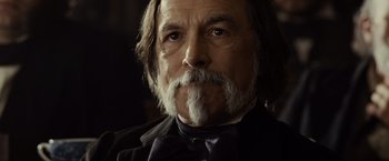 Movie still from “Lincoln” (2012), directed by Steven Spielberg – An older man with long hair and a beard; Close Up shot, Low angle