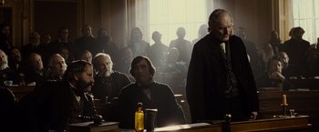Movie still from “Lincoln” (2012), directed by Steven Spielberg – A group of men sitting in front of a window in a room; Medium shot, Over the shoulder angle