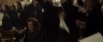 Movie still from “Lincoln” (2012), directed by Steven Spielberg – A group of people standing in a room; Medium shot, Over the shoulder angle