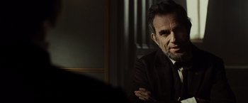 Movie still from “Lincoln” (2012), directed by Steven Spielberg – A man in a suit and tie sitting in front of a mirror; Close Up shot, Over the shoulder angle
