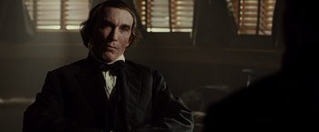 Movie still from “Lincoln” (2012), directed by Steven Spielberg – A person wearing a suit and tie; Close Up shot, Over the shoulder angle