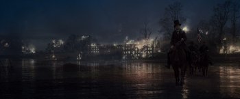 Movie still from “Lincoln” (2012), directed by Steven Spielberg – A dark city with a river and buildings lit up at night time; Extreme Wide shot, High angle