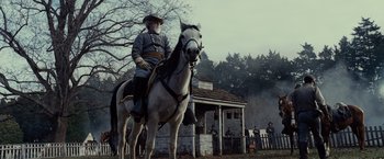 Movie still from “Lincoln” (2012), directed by Steven Spielberg – A man in a civil war uniform riding a horse; Wide shot, Low angle